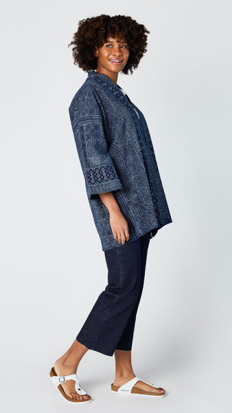 Model wearing indigo block print cotton kimono, white t-shirt, cropped wide leg dark wash jean, and white sandals.