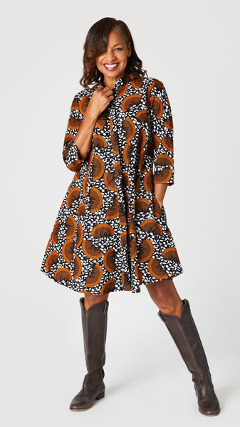 Model wearing “Slice of Life” Zuri dress with brown leather boots.
