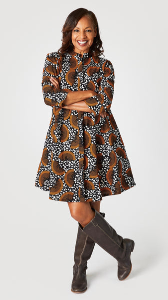 Model wearing “Slice of Life” Zuri dress with brown leather boots.