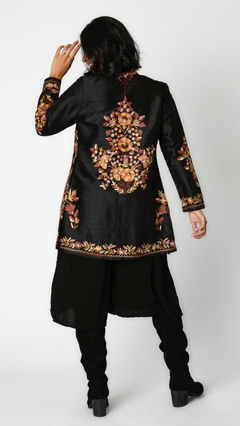 Rearview of jacket shows brown toned embroidered black silk jacket.