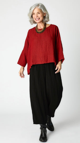 Model wearing cognac cropped one size top in travel weight rayon with black cropped pants with ankle darts and black leather boots.