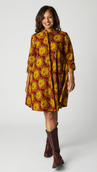 Model wearing "Goldenrod" Zuri Dress with brown leather boots.