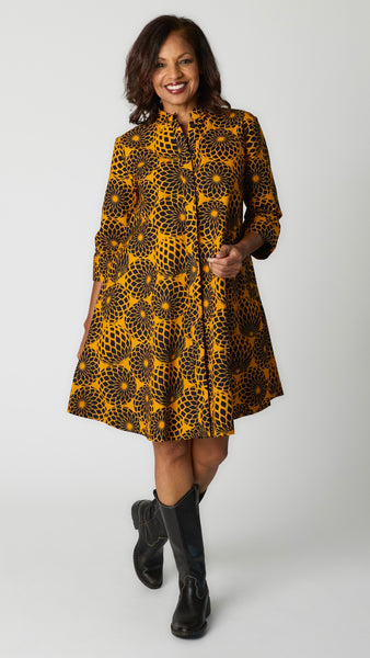 Model wearing Zuri “Blooming” print dress with black leather boots.