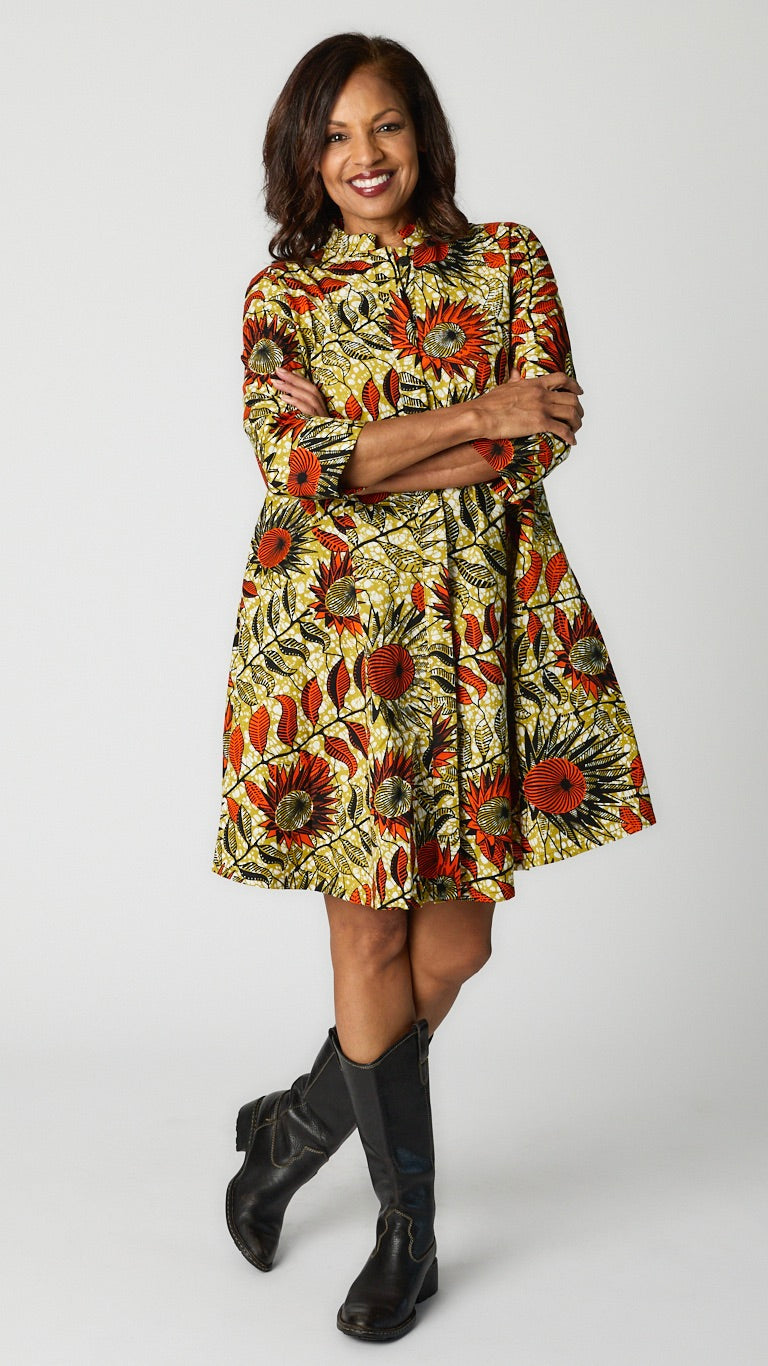 Model wearing Sunflowers Zuri dress with black leather boots.