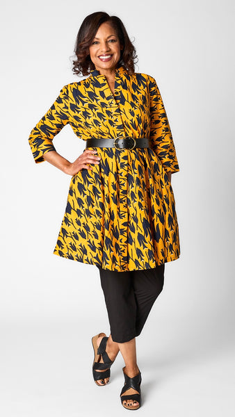 Model wearing "Aerie" print Zuri dress with black cropped poplin pant, black belt with double circle brass buckle, and black sandals.