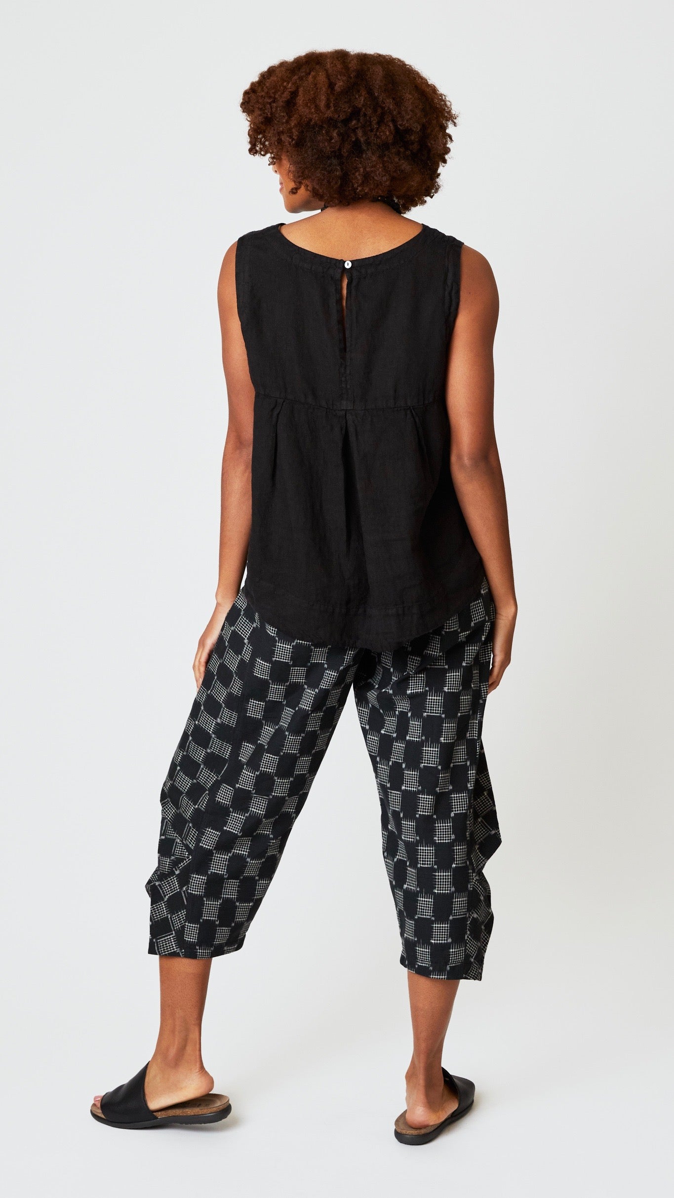 Rear view of sleeveless tank shows keyhole buttonback detail.