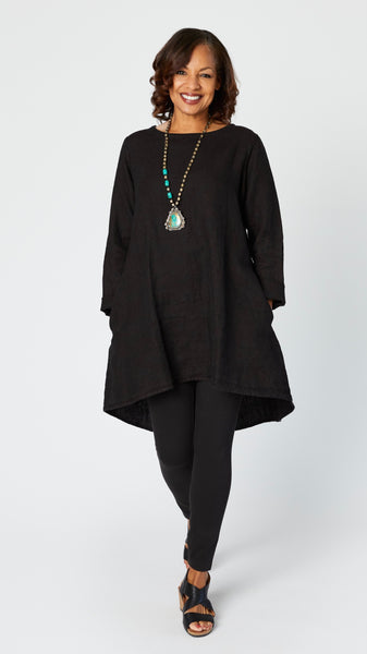Model wearing black linen tunic over black cotton full length legging with turquoise necklace and black leather sandals.