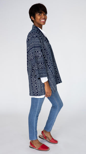 Model wearing indigo block print cotton kimono, white t-shirt, midwash denim leggings, and red slingback flats.