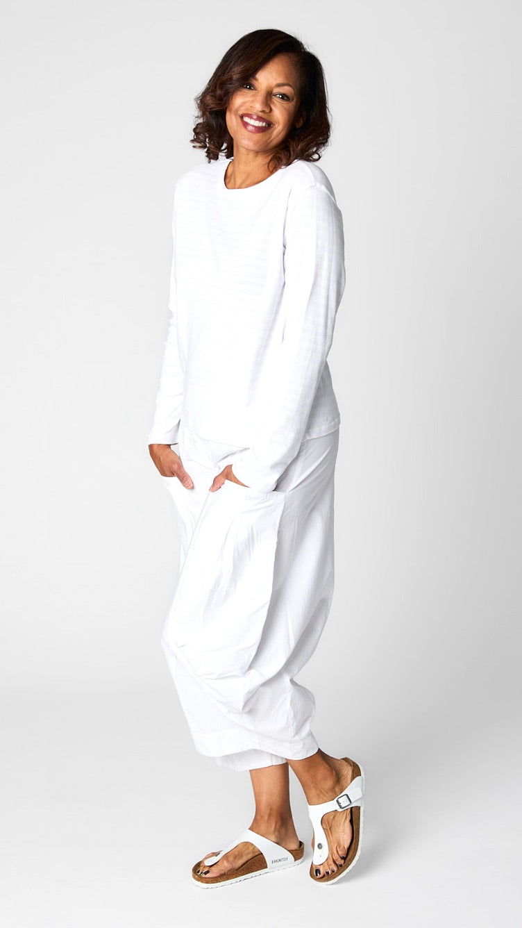 Model wearing "chalk" white monochrome striped long sleeve tee with white cropped double pocket pant in tencel cotton.
