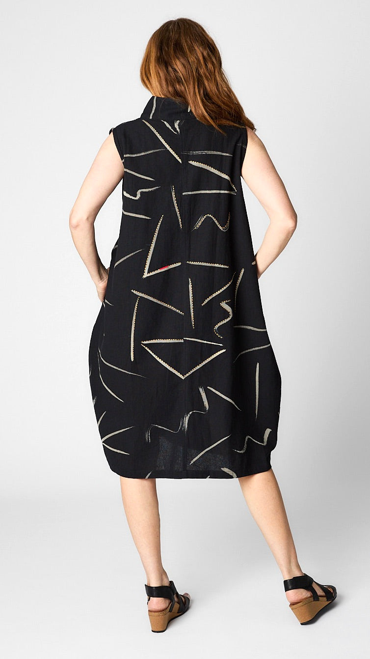 Rear view of dress/vest shows bubble silhouette. 