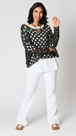 Model wearing charcoal cotton handknit sweater overlay, white cotton-linen blend tunic, and white bootcut jeans.