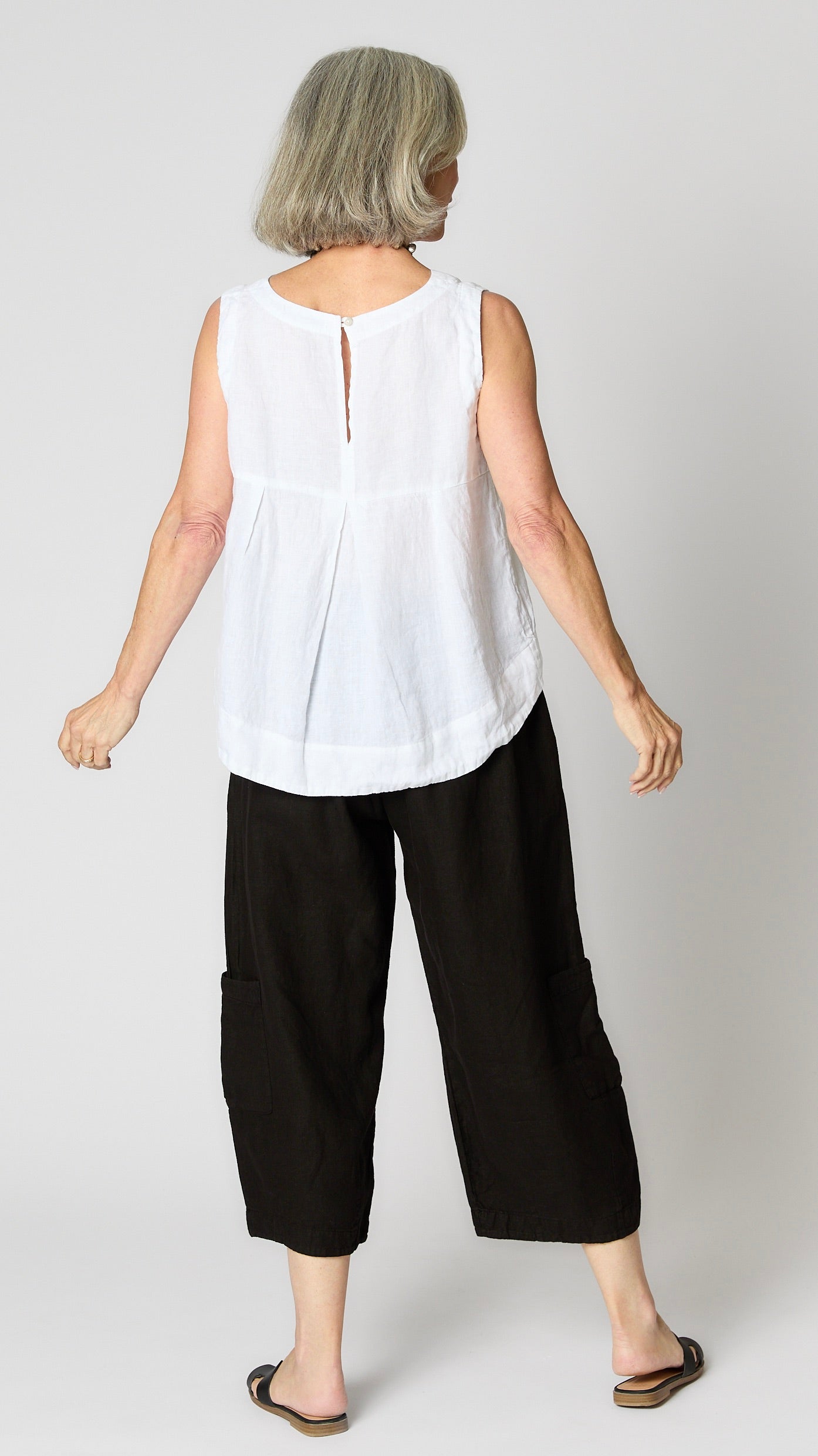 Rear view of sleeveless tank shows keyhole buttonback detail.