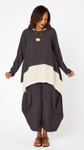 Model wearing black pearl long sleeve cropped top with A-line silhouette, cloud layer tank, and black pearl double pocket pant.