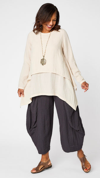 Model wearing cloud long sleeve cropped top with A-line silhouette, cloud layer tank, and black pearl double pocket pant with brown leather sandal.