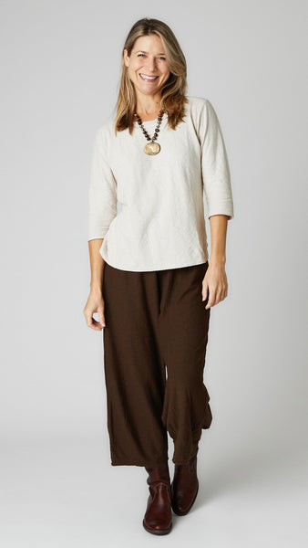 Model wearing natural cotton-linen knit 3/4 sleeve bias cut tee, chocolate cotton-linen knit cropped dart pant, and brown leather boots.