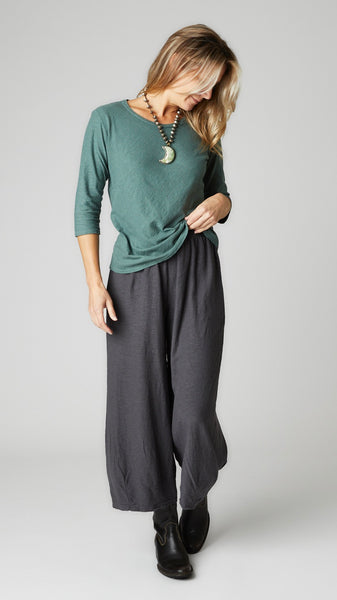 Model wearing myrtle cotton-linen knit 3/4 sleeve bias cut tee, iron cotton-linen knit cropped dart pant, and black leather boots.