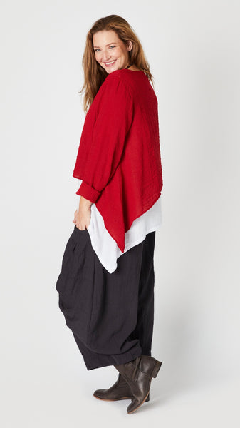 Model wearing red zinc long sleeve cropped top with A-line silhouette, chalk layer tank, and black pearl double pocket pant.