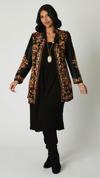 Model wearing black silk duster embroidered in brown tones over black rayon romper and black suede boots.