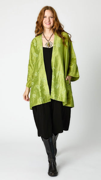 Model wearing citron silk embroidered kimono-style jacket over black rayon romper, black tights, and black leather boots.