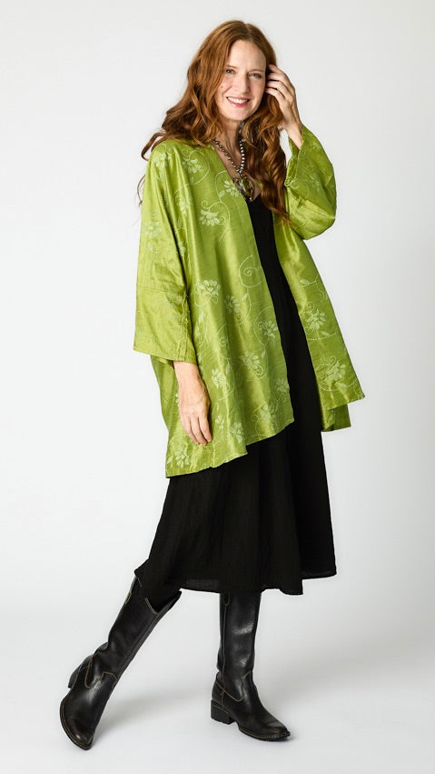 Model wearing citron silk embroidered kimono-style jacket over black rayon romper, black tights, and black leather boots.