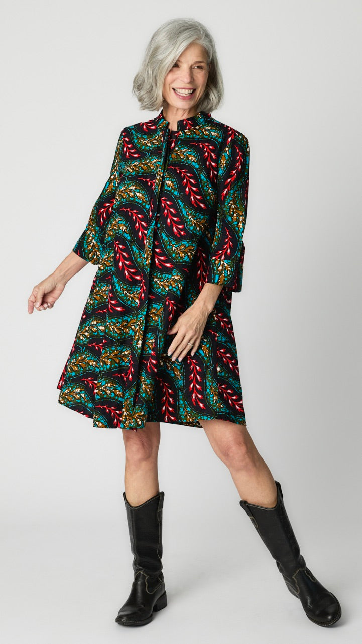 Model wearing "Light as A Feather" Zuri dress with tall black leather boots.