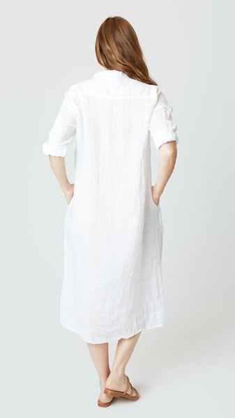 Rear view of chambray linen duster style button-up dress shows back yoke.