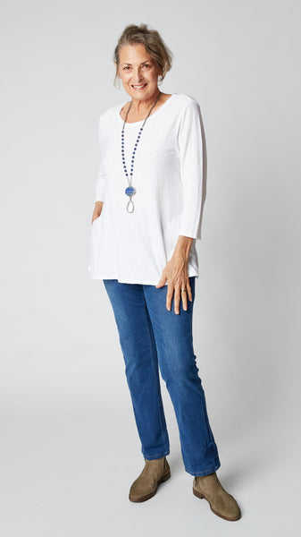 3/4 Sleeved Top in cotton/linen jersey. Crisp White, with pockets in the side seam and frayed rounded neckline. Flares slightly at the hips.